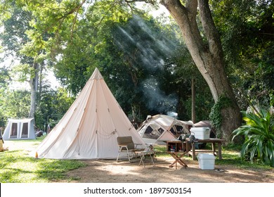 A large white traditional teepee tent with luxurious glamping interiorwith desk and chairs in forest,holidayvacation,Camping
