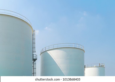 Large white water tank with blue sky.