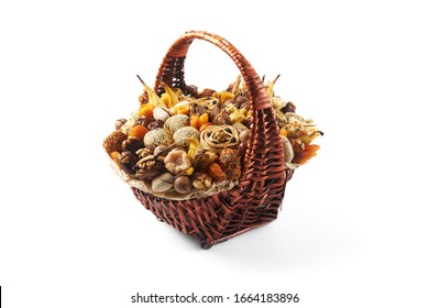 Large Wicker Basket Full Of Nuts And Exotic Dried Fruits As A Gift On A White Background.