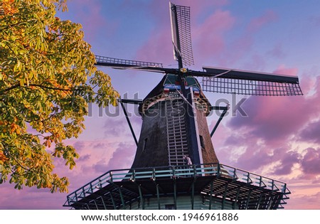 Large windmill seen from below during a beautiful purple sunset.
Traditional dutch windmill in Netherlands.