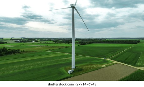 Large windmill spinning under cloudy sky