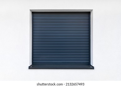 Large Window In Anthracite Color With Fully Covered External Blinds, View From The Outside Of The Building.