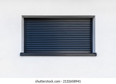 Large Window In Anthracite Color With Fully Covered External Blinds, View From The Outside Of The Building.