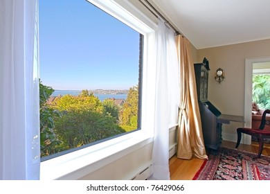 Large window in an old house with a view of the Tacoma old town in the summer.