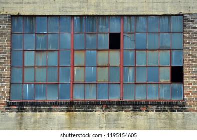 A Large Window On An Old Industrial Building In The Warehouse District Of New Orleans