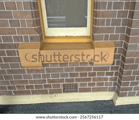 A large window sill at the base of a window in a old commercial building. Tuck pointed wall