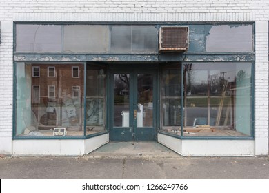 Large Window Storefront With Green And White Paint In Small Town Business District