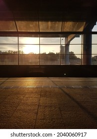 large window at the train station with the reflection of the sun