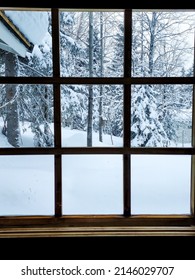 A Large Window With A Wooden Frame, Outside The Window Is A Winter Rural Landscape. Snow-covered Trees And Deep Snow.