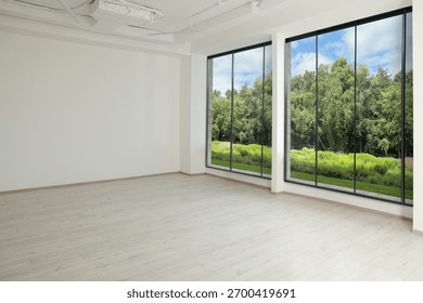 Large windows with garden view in empty room. Interior design