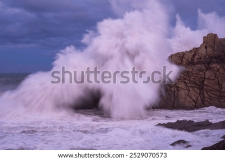 Large winter waves crash overy rocky coast, Playa de la Arnia, Spain