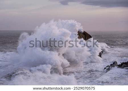 Large winter waves crash overy rocky coast, Playa de la Arnia, Spain