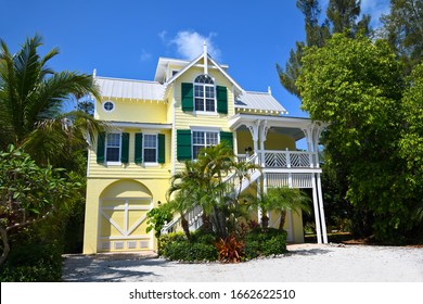 Large Yellow Beach House with deck, garages and beautiful landscaping including Palm Trees near the Beach. Would Make a Great Vacation Rental Property. 