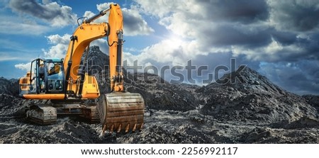 A large yellow excavator moving stone or soil in a quarry. Heavy construction hydraulic equipment. Excavation