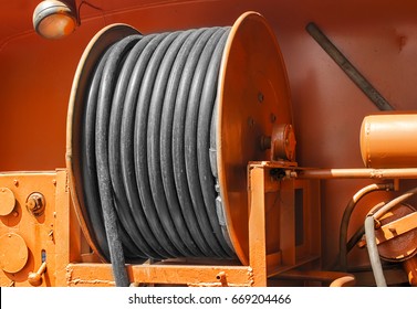 large yellow metal coil with electric cable on a special car outdoor closeup