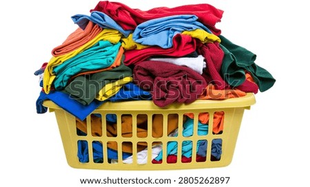 Large yellow plastic laundry basket overflowing with colorful folded clothing
