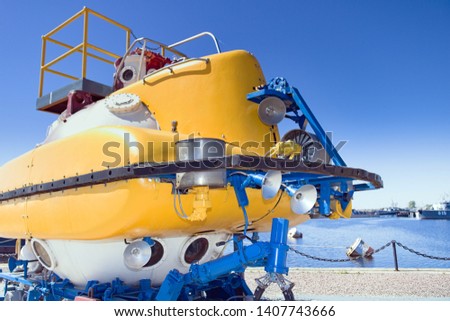 Large yellow rescue bathyscaphe with illuminators and mechanical manipulators