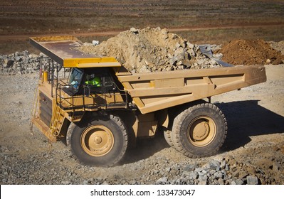 Large Yellow Truck Used In Modern Lithium Mine In Western Australia. A Truck Transports Ore From The Open Cast Mine.