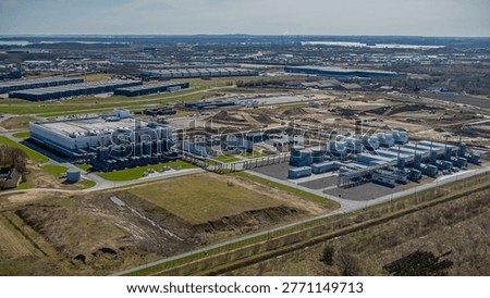 Large-scale data center campus with computing facilities energy supply systems and advanced cooling infrastructure undergoing expansion with visible construction areas, earthworks.
