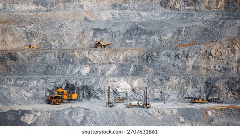 Large-Scale Open Pit Mining Operations with Heavy Machinery on Rocky Terrain.