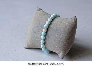 Larimar bracelet. A bracelet made of stones on a hand from natural stone Larimar. Bracelet made of natural stones. Handmade jewelry. Handmade bracelets on light modern background.