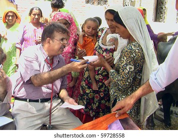LARKANA, PAKISTAN - AUG 18: An unidentified doctor examines gastro patients at a flood affected relief camp on August 18, 2010 in Larkana, Pakistan. (Javed Shah/PPI Photo)