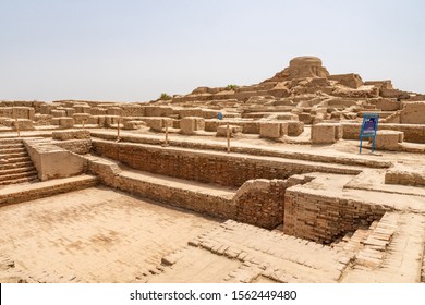 LARKANA, PAKISTAN - JUNE 2019: Mohenjo Daro Archaeological UNESCO World Heritage View Of Great Bath On A Sunny Blue Sky Day