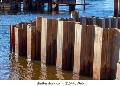 Larsen Sheet Piling In The River. Steel Piles To Strengthen The Shore In The Water