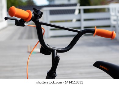 Larvik, Norway - May 31st 2019: Black Kids Bike With Orange Details. 