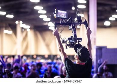 LAS VEGAS - AUGUST 3, 2019: Camera man operating wireless stabilized recording equipment at eSports fighting game tournament EVO 2019 Evolution Championship Series at Mandalay Bay Events Center.
