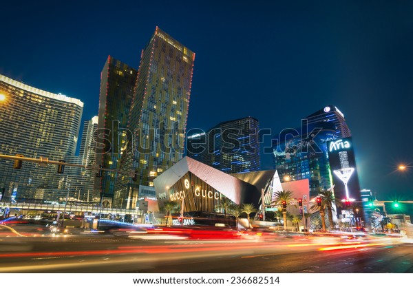 LAS VEGAS - DECEMBER 7, 2013: blurred lights on the
Strip at sunset. Aria Resort and Casino is a luxury accommodation
building, part of City Center complex on the Las Vegas Boulevard in
Nevada Usa 