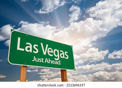 Las Vegas Green Road Sign Over Dramatic Blue Sky And Clouds.