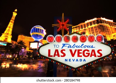 LAS VEGAS - MAY 12 : Welcome to fabulous Las Vegas neon sign with Las Vegas strip road background View of the strip on May 12, 2015