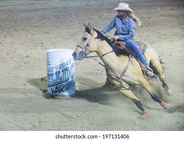LAS VEGAS - MAY 16 : Cowgirl Participating in a Barrel racing competition at the Helldorado Days Rodeo , A professional rodeo held in Las Vegas , Nevada on May 16 2014 