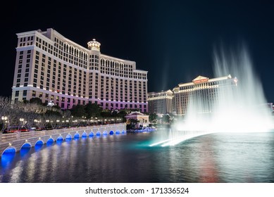 LAS VEGAS, NEVADA - DECEMBER 24: Bellagio Hotel and Casino and water fountain at night with Caesars Palace in Las Vegas, NV, on December 24, 2013.