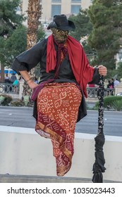 Las Vegas, Nevada / March 8, 2015: Street Performer Dressed In Red And Black Appears To Be Levitating.
