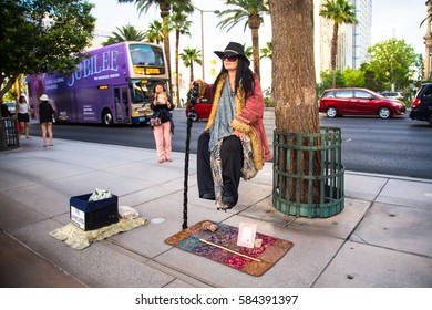 LAS VEGAS, NEVADA - MAY 7, 2014: View Of Street Performer Doing Levitation Act Along Las Vegas Boulevard.