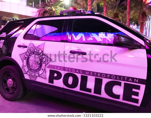 LAS VEGAS, NEVADA, USA - FEBRUARY 2019:\
Patrol car of the Las Vegas Metropolitan Police Department parked\
under the neon lights of Las Vegas\
Boulevard.