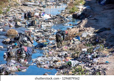 Las Vegas, Nevada/USA - January 5, 2019: Person Searches Through Trash In Waterway Filled With Trash Near Las Vegas Strip - Homeless Pollution Environment America 