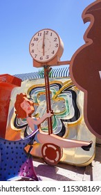 Las Vegas, Nevada/USA: May 12, 2018- Clock And Lady Swinging Vintage Casino Sign At The Neon Museum