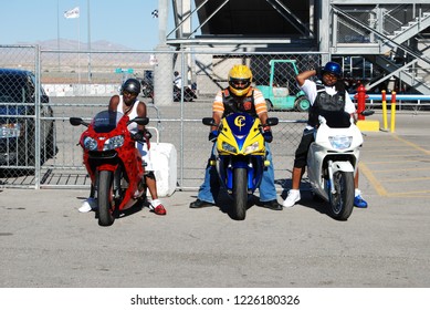 Las Vegas, Nevada/USA-August 6, 2011: Three African American Bikers Prepare To Ride The Custom Sport Bikes Under Their Control With The Vegas Speedway Stadium In The Background And A Clear Path Ahead.