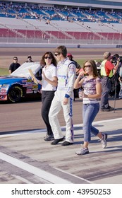 LAS VEGAS, NV - SEPTEMBER 26: Colin Braun Walks The Pit Area With Team Member Laurie, And His Girlfriend Melissa Fields Before The Sept. 26, 2009 Las Vegas 350 Race.