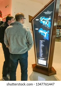 LAS VEGAS, NV, USA - FEBRUARY 2019: Two People Looking At A Map And Store Directory Of The Shops At Crystals Mall In Las Vegas.