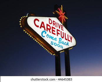 Las Vegas Sign At Night Reading Drive Carefully And Come Back Soon. Horizontally Framed Shot.