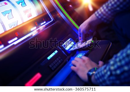 Las Vegas Slot Gambling Addiction. Men Playing Traditional Slot Machine.