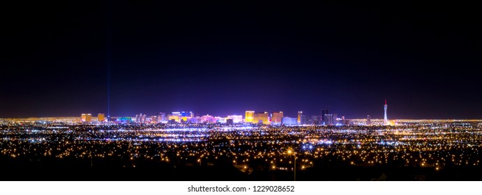 Las Vegas strip and city skyline at night panorama with casino lights and hotels from a far distance - Shutterstock ID 1229028652