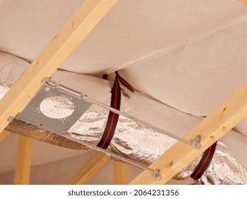 Las Vegas, United States-October 23, 2021:  Close-up New HVAC Duct, Hanger Strap, Cathedral Ceiling Insulation, And Light Fixture Hanger.  New Residential Home Construction Mechanical System Details.