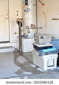 Las Vegas, United States-October 6, 2021:  Broken Water Heater Flooding Garage. Fifty Gallon Hot Water Heater Leaking In Residential Garage.