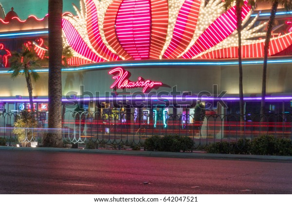 Las Vegas, USA - Circa 2017: Long exposure\
light trails outside Flamingo hotel casino resort on Las Vegas\
blvd. Car traffic drives by at\
night