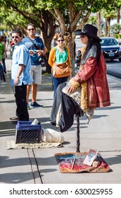 Las Vegas, USA - May 7, 2014: Street Performer Magician Sitting Suspended In Air Holding A Cane